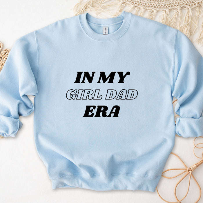 a light blue sweatshirt that says in my girl dad era