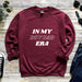 a maroon sweatshirt with the words in my boy dad era printed on it