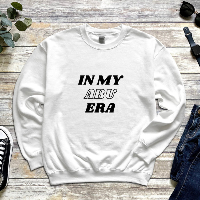 a white sweatshirt with the words in my aru era printed on it