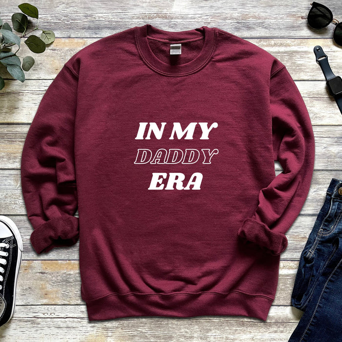 a maroon sweatshirt that says in my daddy era