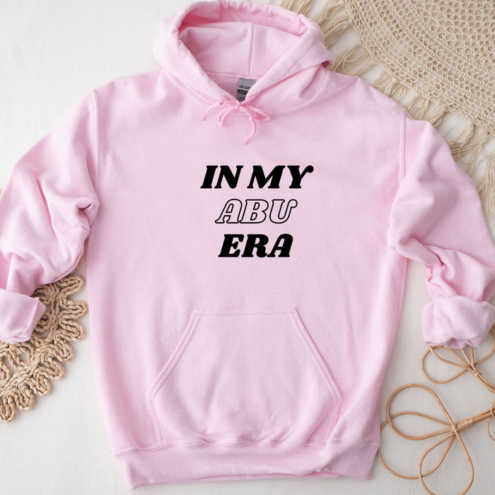 a pink hoodie that says in my abu era