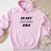 a pink hoodie that says in my father era