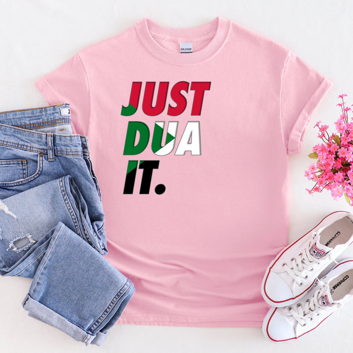 a pink t - shirt that says just dua it next to a pair of