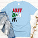 a t - shirt that says just dua it next to a pair of shoes