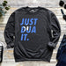 a sweatshirt that says just dua it next to a pair of jeans